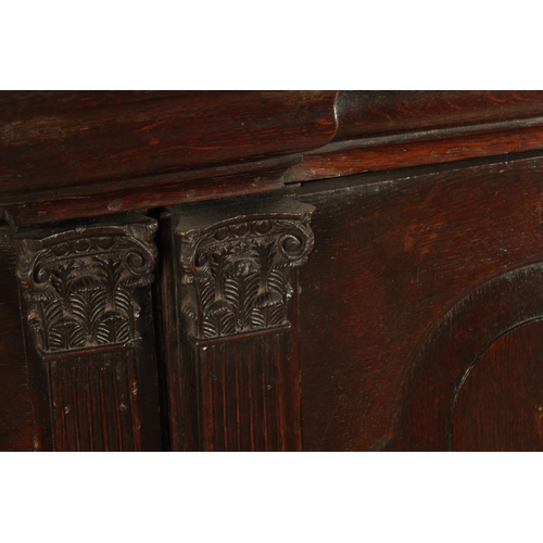 827 - AN EARLY 18TH CENTURY ARCHITECTURAL OAK BOOKCASE the deep moulded cornice above a pair of raised fie... 