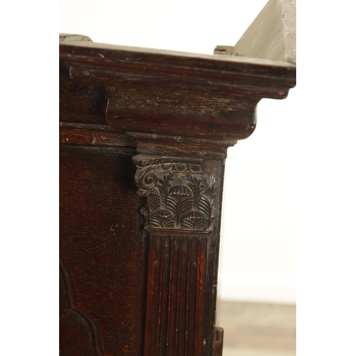 827 - AN EARLY 18TH CENTURY ARCHITECTURAL OAK BOOKCASE the deep moulded cornice above a pair of raised fie... 