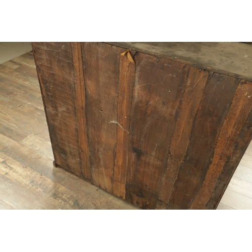 827 - AN EARLY 18TH CENTURY ARCHITECTURAL OAK BOOKCASE the deep moulded cornice above a pair of raised fie... 