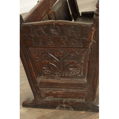 831 - A 17TH CENTURY WESTMORLAND JOINED OAK CRADLE with leaf carved panelled body and raised turned uprigh... 