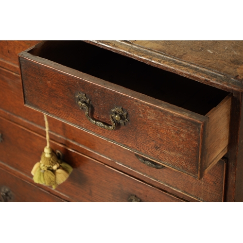 832 - A SMALL EARLY GEORGE III OAK CHEST OF DRAWERS with cross-banded top above two small and three long g... 