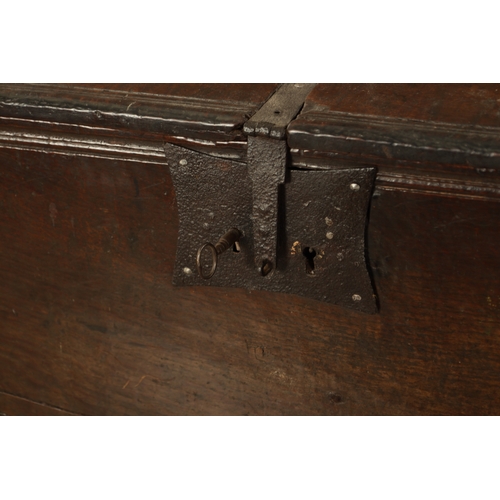 834 - A LARGE EARLY 17TH CENTURY OAK SIX PLANK COFFER of unusually large size having ironwork strap hinges... 