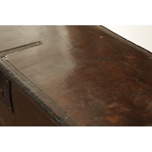 834 - A LARGE EARLY 17TH CENTURY OAK SIX PLANK COFFER of unusually large size having ironwork strap hinges... 