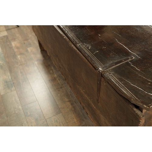 834 - A LARGE EARLY 17TH CENTURY OAK SIX PLANK COFFER of unusually large size having ironwork strap hinges... 