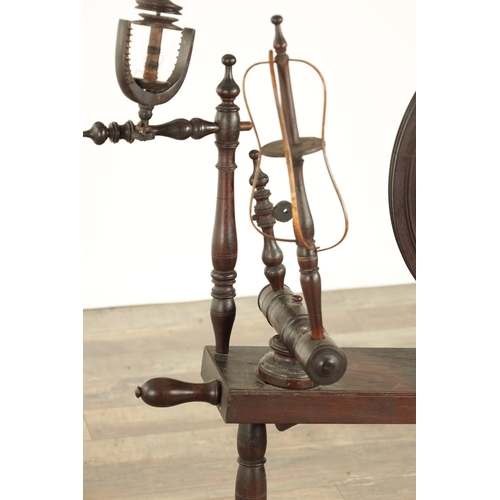 838 - A 19TH CENTURY OAK SPINNING WHEEL with raised super-structure (93cm high 83cm wide )