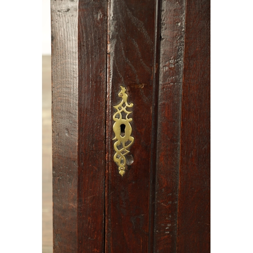 843 - AN EARLY 18TH CENTURY OAK HANGING CORNER CUPBOARD with hinged fielded panelled door and frieze drawe... 