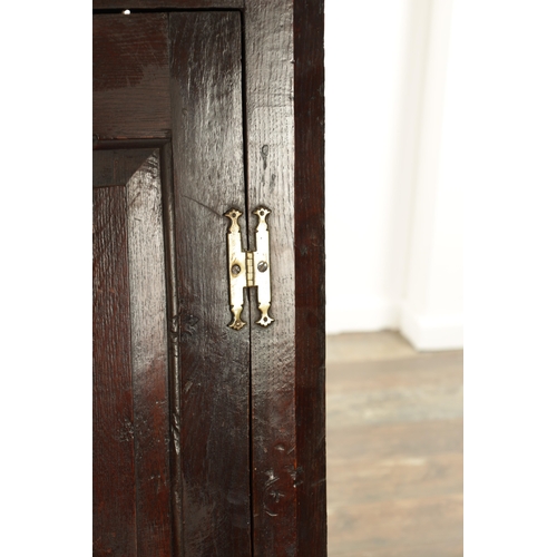 843 - AN EARLY 18TH CENTURY OAK HANGING CORNER CUPBOARD with hinged fielded panelled door and frieze drawe... 