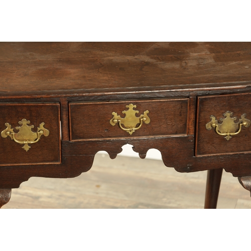 845 - AN 18TH CENTURY OAK LOWBOY with moulded edge top above three drawers and shaped frieze; raised on ca... 