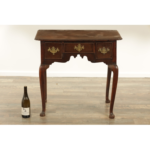 845 - AN 18TH CENTURY OAK LOWBOY with moulded edge top above three drawers and shaped frieze; raised on ca... 