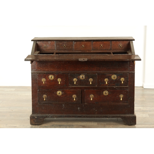 849 - AN EARLY PRIMITIVE 17TH CENTURY JOINED OAK BUREAU with shallow fall front and fitted small drawers a... 