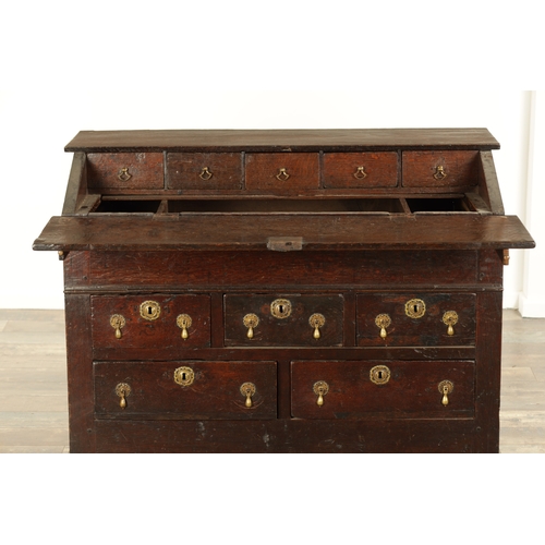 849 - AN EARLY PRIMITIVE 17TH CENTURY JOINED OAK BUREAU with shallow fall front and fitted small drawers a... 