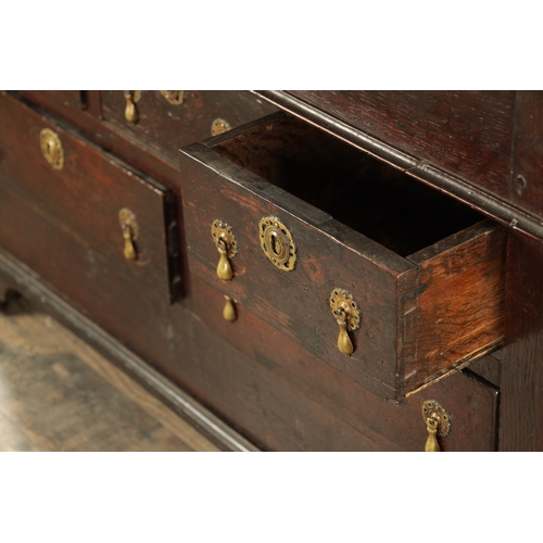 849 - AN EARLY PRIMITIVE 17TH CENTURY JOINED OAK BUREAU with shallow fall front and fitted small drawers a... 