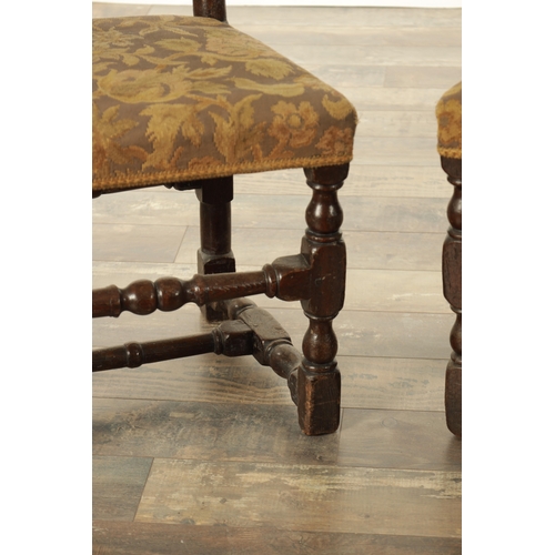 854 - A PAIR OF 17TH CENTURY OAK HALL CHAIRS with scroll-carved top rails above slatted backs, having upho... 