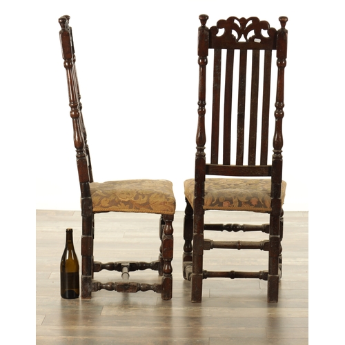 854 - A PAIR OF 17TH CENTURY OAK HALL CHAIRS with scroll-carved top rails above slatted backs, having upho... 