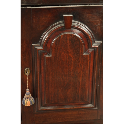 858 - A GOOD EARLY 18TH CENTURY WALNUT HANGING CORNER CUPBOARD with arched panelled door above a single dr... 