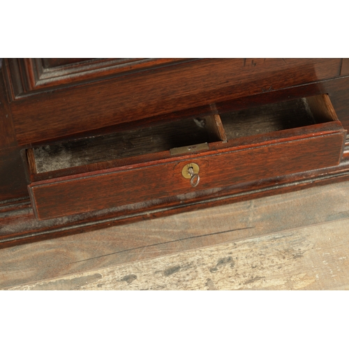 858 - A GOOD EARLY 18TH CENTURY WALNUT HANGING CORNER CUPBOARD with arched panelled door above a single dr... 