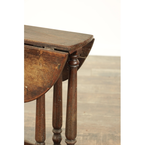 861 - A CHARLES II STYLE MINIATURE OAK DROP LEAF GATE LEG TABLE with turned supports and solid sledge base... 