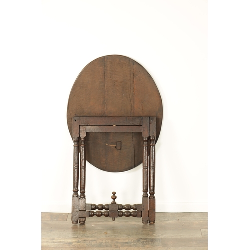 862 - AN EARLY 18TH CENTURY OAK FOLDING TAVERN TABLE with an oval top above a turned folding base (70cm wi... 