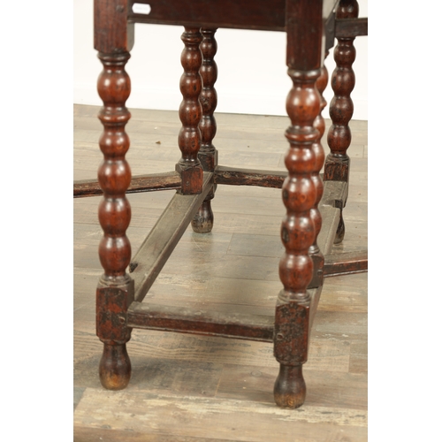 866 - AN EARLY 18TH CENTURY JOINED OAK GATE LEG TABLE the oval top on a bobbin-turned base with under stre... 