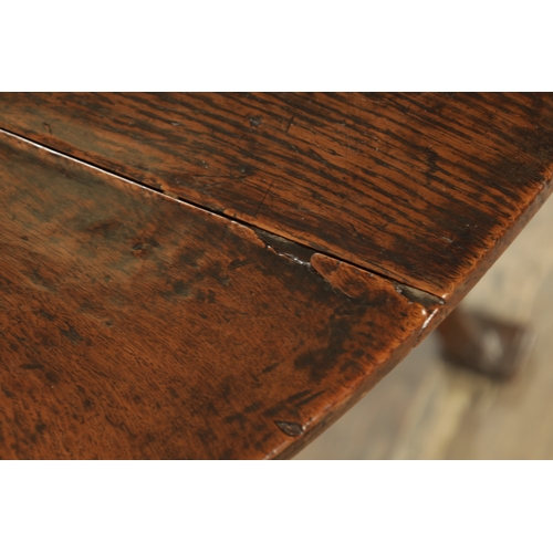 875 - AN EARLY QUEEN ANNE OAK GATE LEG TABLE with hinged drop sides, mounted on a square cut-out frieze ra... 