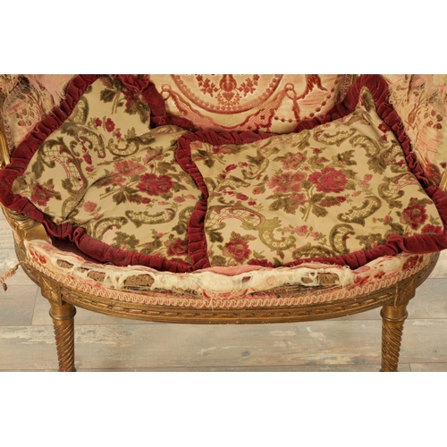 876 - A 19TH CENTURY FRENCH GILT WOOD LOVING SEAT with a leaf-carved frame and upholstered seat. (88cm wid... 