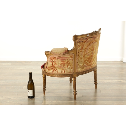 876 - A 19TH CENTURY FRENCH GILT WOOD LOVING SEAT with a leaf-carved frame and upholstered seat. (88cm wid... 