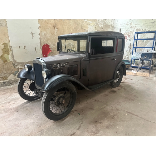 751 - A 1931 AUSTIN SALOON MOTOR CAR in need of restoration, original moroon and black paint and registrat... 