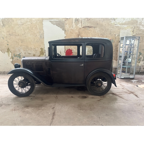 751 - A 1931 AUSTIN SALOON MOTOR CAR in need of restoration, original moroon and black paint and registrat... 