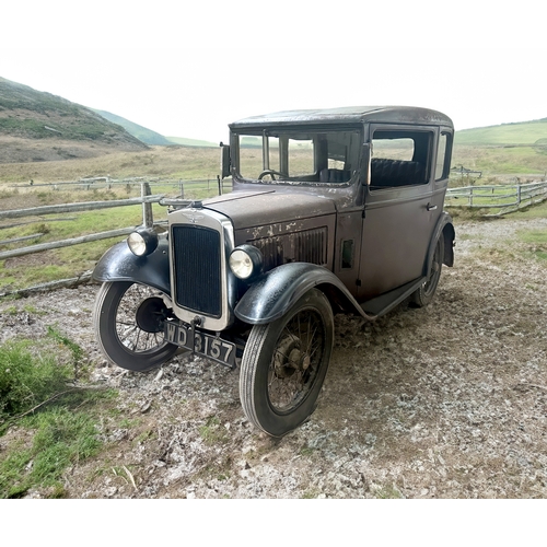 751 - A 1931 AUSTIN SALOON MOTOR CAR in need of restoration, original moroon and black paint and registrat... 