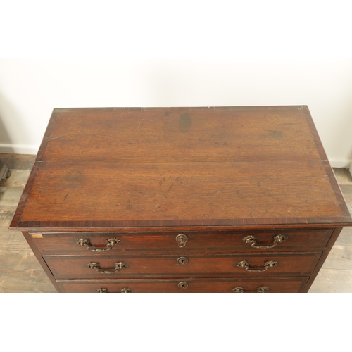 857 - A GEORGE III OAK AND WALNUT CROSS-BANDED CHEST OF DRAWERS with Rococo style gilt brass handles and b... 