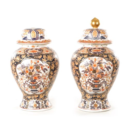 109 - A PAIR OF 19TH CENTURY STYLE IMARI VASES AND COVERS with polychrome coloured decoration and gilt hig... 