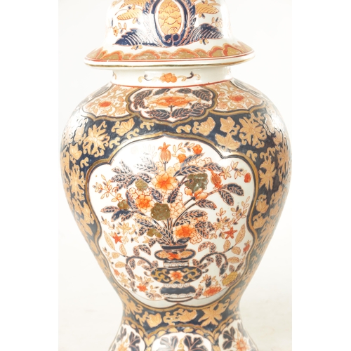 109 - A PAIR OF 19TH CENTURY STYLE IMARI VASES AND COVERS with polychrome coloured decoration and gilt hig... 