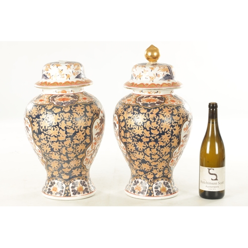 109 - A PAIR OF 19TH CENTURY STYLE IMARI VASES AND COVERS with polychrome coloured decoration and gilt hig... 