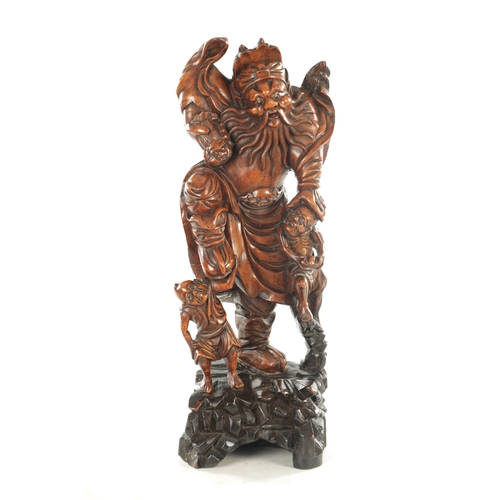 119 - A 19TH CENTURY CHINESE CARVED BOXWOOD STATUE OF A BEARDED IMMORTAL on a hardwood base (59cm high )