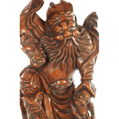 119 - A 19TH CENTURY CHINESE CARVED BOXWOOD STATUE OF A BEARDED IMMORTAL on a hardwood base (59cm high )