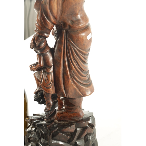 119 - A 19TH CENTURY CHINESE CARVED BOXWOOD STATUE OF A BEARDED IMMORTAL on a hardwood base (59cm high )