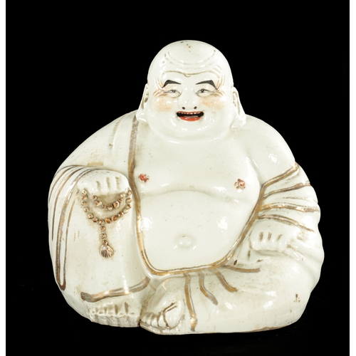 131 - A 19TH CENTURY CHINESE PORCELAIN STATUE OF A SEATED BUDDHA with iron red highlights - having impress... 