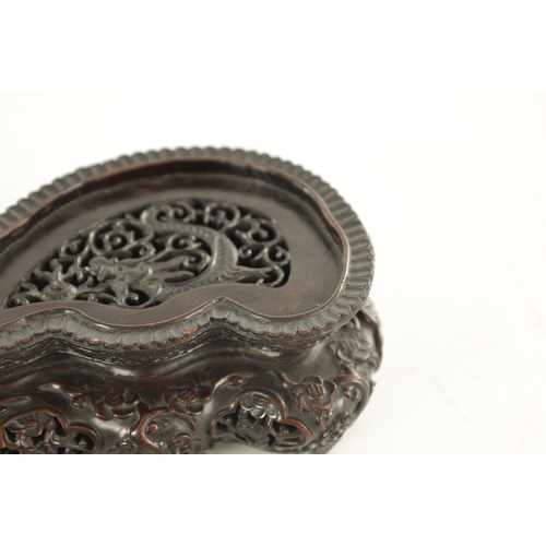 142 - A PAIR OF 19TH CENTURY CHINESE HARDWOOD STANDS AND ANOTHER of shaped pierced form with finely carved... 