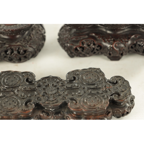 142 - A PAIR OF 19TH CENTURY CHINESE HARDWOOD STANDS AND ANOTHER of shaped pierced form with finely carved... 