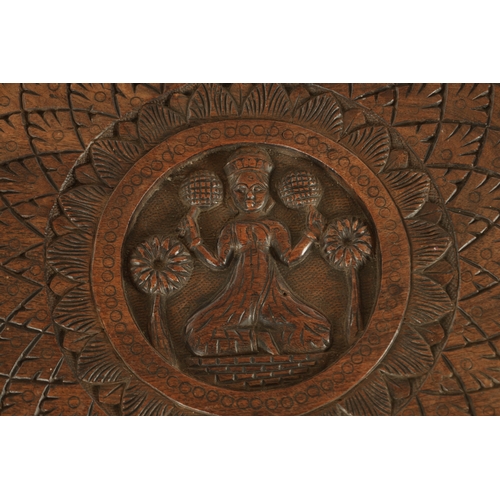 143 - A 19TH CENTURY INDIAN CARVED HARDWOOD OCCASIONAL TABLE the circular carved top above three elephant'... 