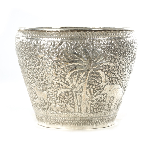 153 - A LARGE LATE 19TH CENTURY INDIAN SILVER METAL JARDINIERE with elephants and animals amongst palm tre... 