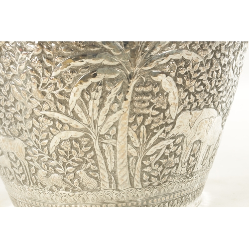 153 - A LARGE LATE 19TH CENTURY INDIAN SILVER METAL JARDINIERE with elephants and animals amongst palm tre... 