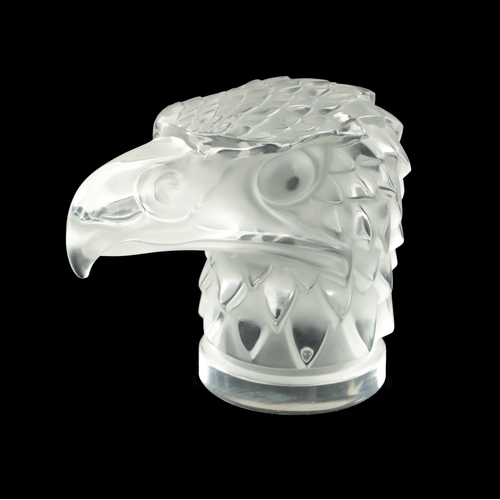 16 - A RENE LALIQUE STYLE 'TETE D'AIGLE' CLEAR AND FROSTED GLASS CAR MASCOT on a circular base moulded si... 