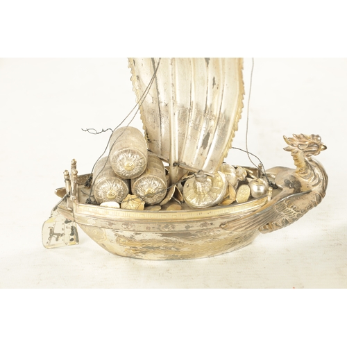 175 - A JAPANESE MEIJI PERIOD SILVER AND SILVER GILT TAKARABUNE modelled as a sailing treasure ship with a... 