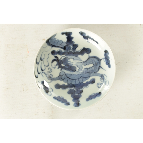 178 - AN 18TH CENTURY JAPANESE BLUE AND WHITE PORCELAIN DISH painted with a dragon amongst clouds - signed... 