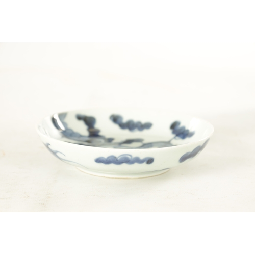 178 - AN 18TH CENTURY JAPANESE BLUE AND WHITE PORCELAIN DISH painted with a dragon amongst clouds - signed... 