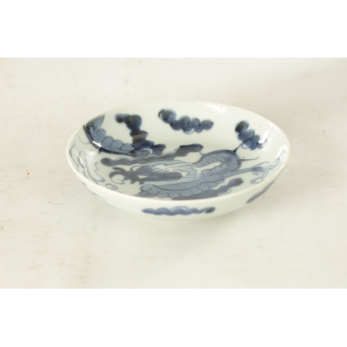 178 - AN 18TH CENTURY JAPANESE BLUE AND WHITE PORCELAIN DISH painted with a dragon amongst clouds - signed... 