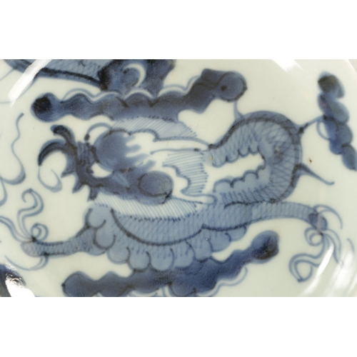 178 - AN 18TH CENTURY JAPANESE BLUE AND WHITE PORCELAIN DISH painted with a dragon amongst clouds - signed... 