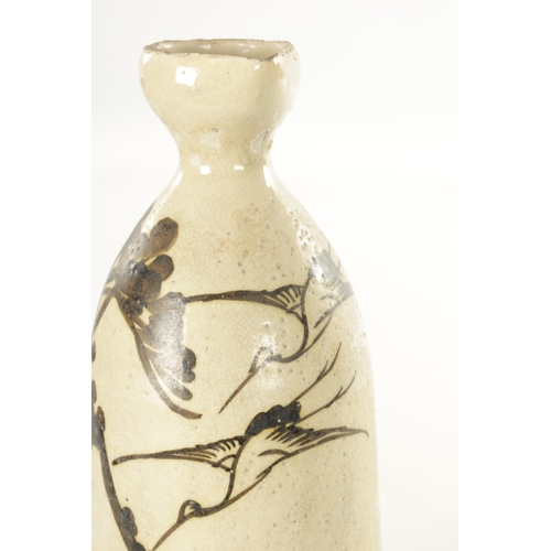 190 - A JAPANESE EDU PERIOD POTTERY SAKI FLASK with painted decoration depicting flying birds and blossomi... 