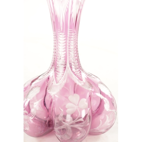 26 - AN EARLY 20TH CENTURY SILVER TOPPED INTAGLIO CUT GLASS PINK TINTED DECANTER decorated with flower he... 